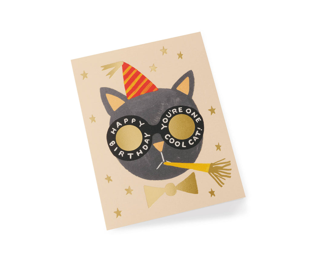 The Birthday Cat Card features a black cat in a red and yellow party hat with round glasses, "Happy Birthday" and "You're One Cool Cat" text, gold star accents, metallic foil stamping, and a blank interior for your message.