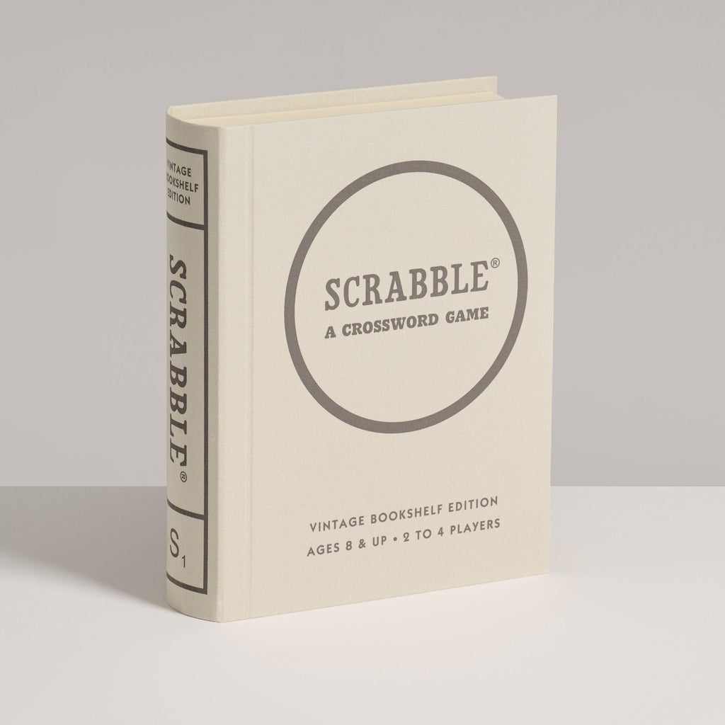 The Scrabble Vintage Bookshelf Edition is a cream-colored, book-shaped box that stands upright and features premium game components. It’s designed for 2–4 players ages 8 and up.
