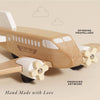 The Wooden Toy Plane is a plastic-free, hand-made toy crafted from FSC-certified wood, featuring spinning propellers, engraved artwork, and “Le Toy Van Airlines” labeling. Shown on a beige background with simple cloud illustrations.
