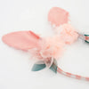 The Embellished Gingham Bunny Headband features soft pink rabbit ears adorned with peach tulle and green leaves on a white background, with organza flowers adding a whimsical, delicate touch.