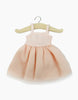 A charming Minikane Doll Clothing piece, the Rosella Tutu in Pale Pink, is displayed on a wooden hanger against a plain white background. This light pink sleeveless dress features a fitted bodice and a flared skirt, designed in France for an elegant touch. It's hand washable for easy care.
