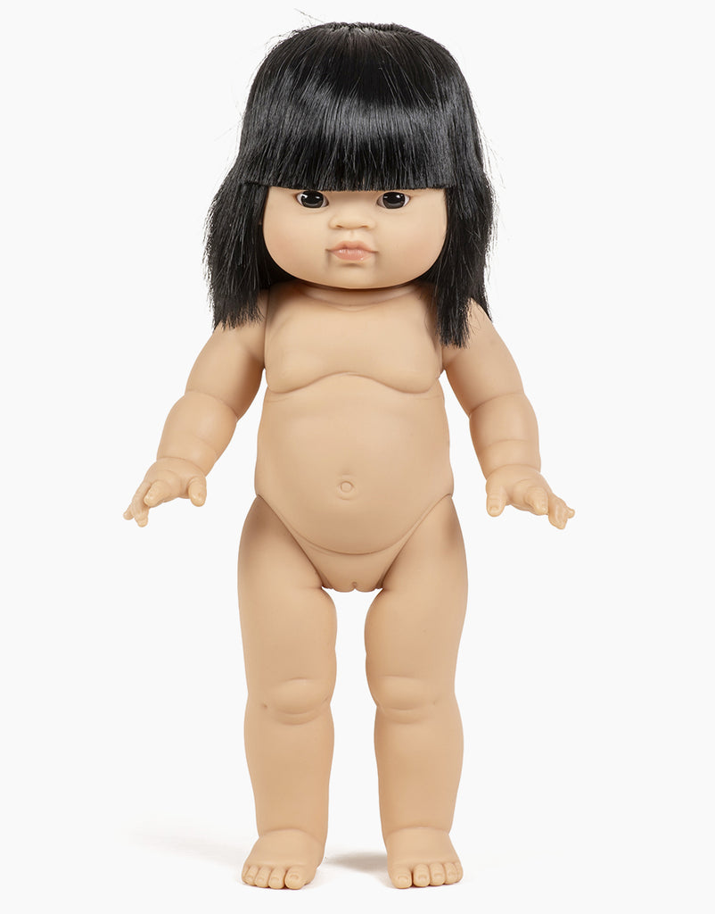 The Minikane Standing Doll (14") - Jade comes with clothing and sunglasses, featuring straight black hair and a neutral expression. It is anatomically correct with articulated arms and legs, set against a plain white background.