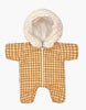 The Minikane Doll Clothing | Vichy Caramel Pilot Suit is a cozy baby onesie adorned with a brown and white checkered pattern, reminiscent of a ski suit. It features a fluffy white hood for added warmth and includes a convenient front zipper closure, making it perfect for keeping little ones snug.