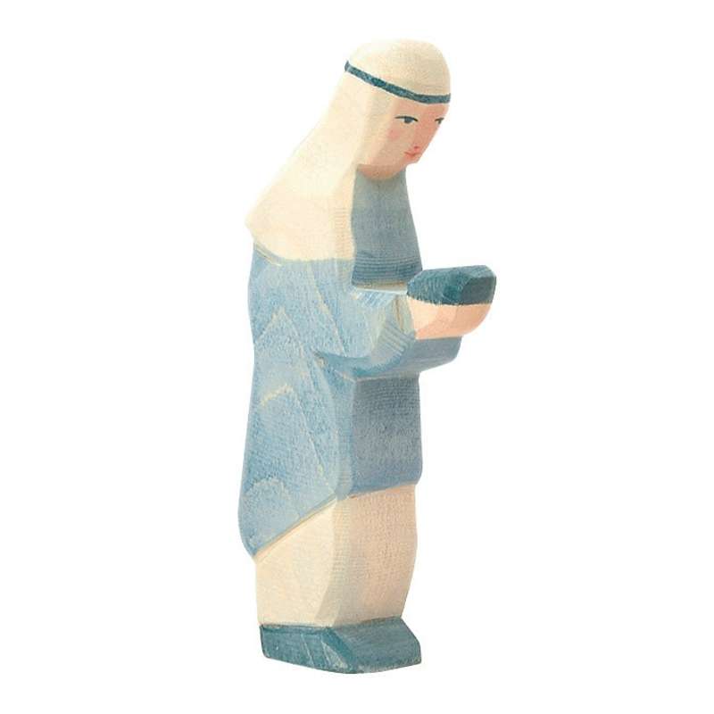 A Ostheimer Blue King figurine, handcrafted in soft pastel blues and whites, depicted standing and holding a small bowl. The figure has simple, stylized features with a serene expression.