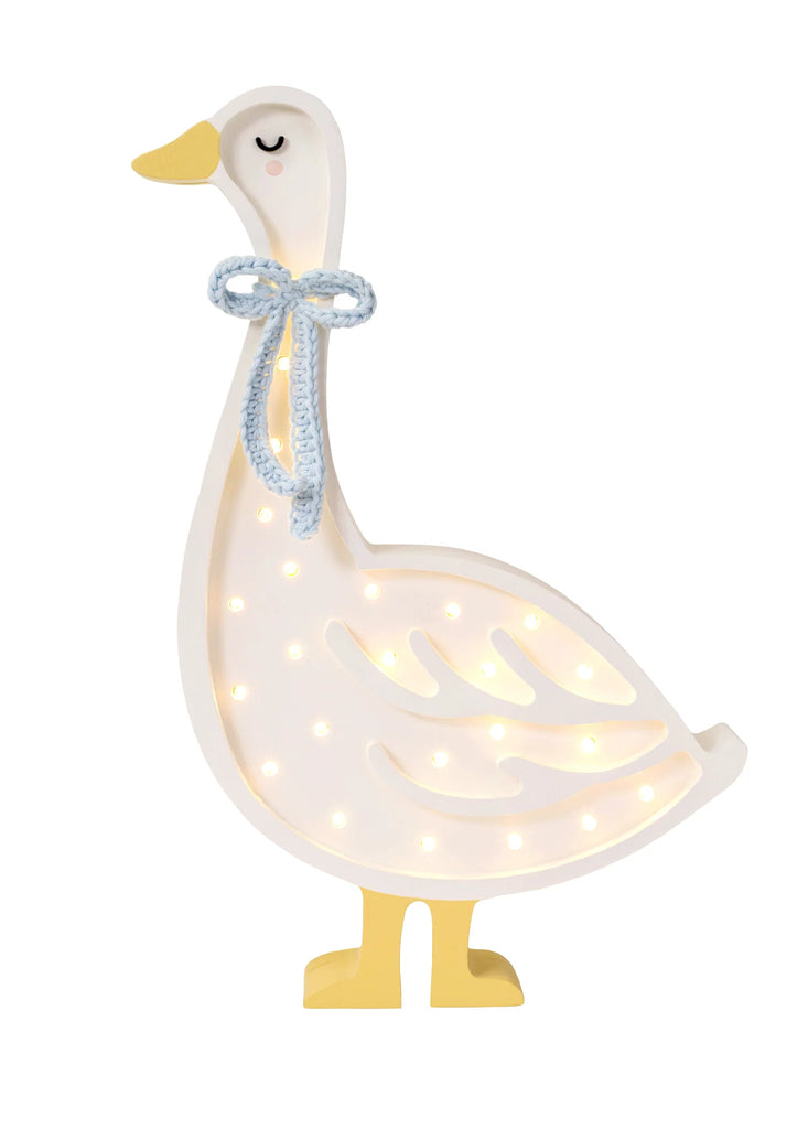 A Handmade Wooden Goose Lamp with a blue knitted bow around its neck. The white body has cut-out patterns allowing light to shine through, creating a soft, warm glow—perfect nursery decor. The goose's yellow feet and beak add charm, while its closed eyes give it a peaceful appearance.