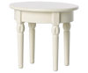 The Maileg Kitchen Set includes a small, white side table with a round top and four cylindrical legs, making it a charming accent in any room.