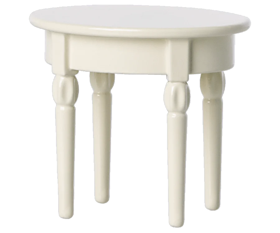 The Maileg Kitchen Set includes a small, white side table with a round top and four cylindrical legs, making it a charming accent in any room.