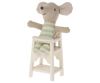 A Maileg Mouse Size High Chair, featuring a stuffed mouse toy with gray and white coloring and green-striped limbs, positioned against a plain background.