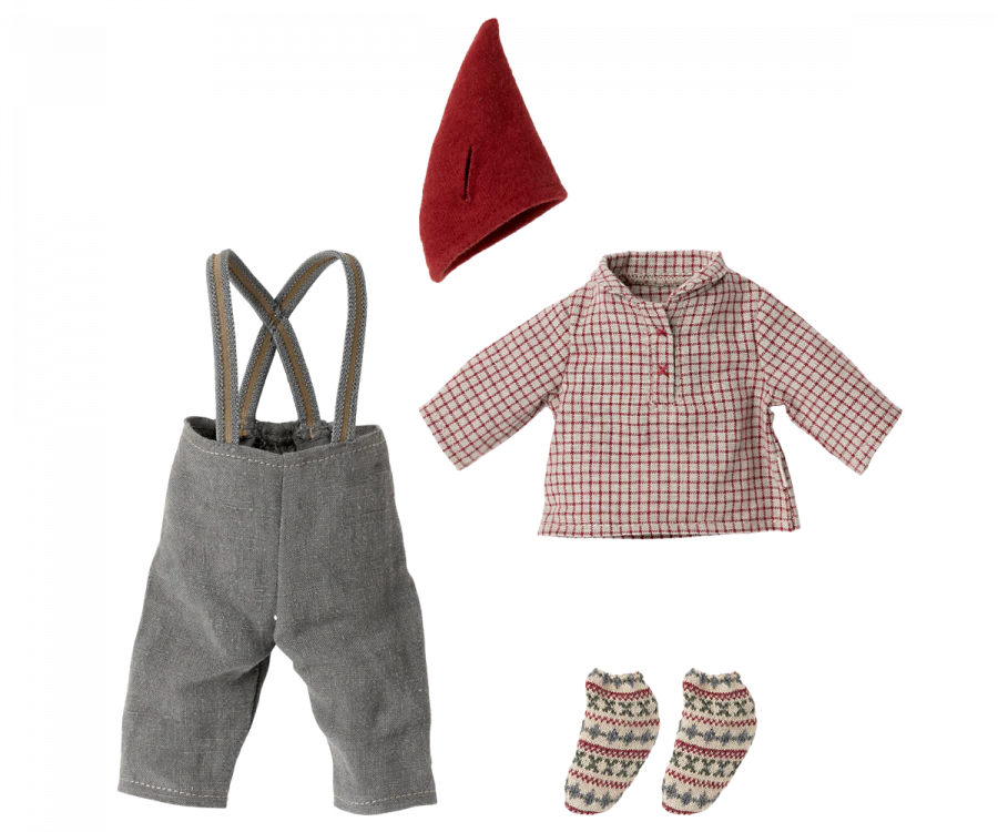 A child's outfit is laid out, featuring cozy clothes: gray pants with suspenders, a red and white checkered long-sleeve shirt, a red pointed hat reminiscent of the Maileg Medium Christmas Mouse, and a pair of knitted socks with a festive red and green pattern.