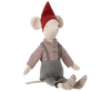 The Maileg Medium Christmas Mouse is dressed in a red pointed hat, a checkered shirt, grey overalls with suspenders, and patterned socks. The toy is seated with its legs extended forward.