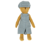 The bear named Teddy Junior is dressed in a blue and white striped outfit, consisting of overalls and a matching cap from the Maileg Extra Clothing collection. This outfit, which can be purchased separately as "Overall and Cap for Teddy Junior," dresses the brown teddy bear that stands upright with its arms at its sides.