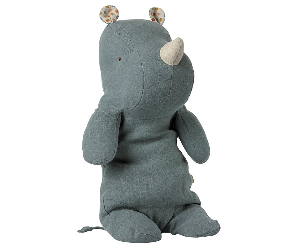 Introducing the Maileg Medium Rhino: a soft, gray-green rhino plush toy made from linen. It features a small horn, fabric ears with colorful dots, and sits upright with tucked legs. This charming friend is perfect for hugs and boasts a simple yet cute design.