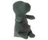 A Maileg Small Gantosaurus in egg - Green toy in a seated position, featuring a soft green fabric with visible stitching and wear, giving it a huggable, well-loved appearance. The toy is isolated against a solid background.