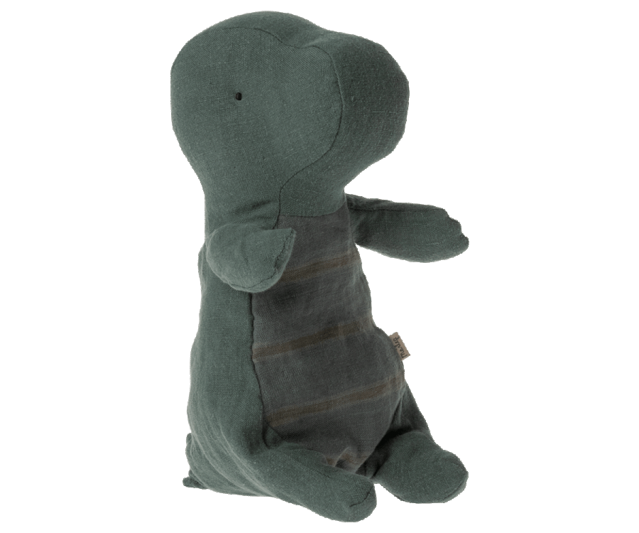 A Maileg Small Gantosaurus in egg - Green toy in a seated position, featuring a soft green fabric with visible stitching and wear, giving it a huggable, well-loved appearance. The toy is isolated against a solid background.
