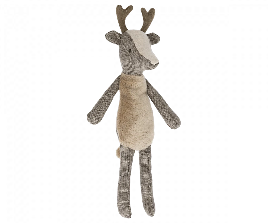 A small deer stuffed animal with antlers photographed on a flat background.