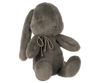 Grey plush bunny with bow around its neck. 