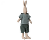 A Maileg Rabbit, Size 2 - Classic Shirt & Shorts, crafted from soft natural linen, wears a light blue shirt with a hood and dark green shorts. The rabbit stands upright with its long ears pointing up and has a simple, stitched facial expression. Perfect for any Maileg dollhouse collection.