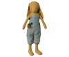 A soft, Maileg Bunny Size 3, Dusty Yellow doll wearing a plaid blue and beige jumpsuit from its charming Bunny/Rabbit 3 wardrobe, standing upright with long ears and holding a small toy camera.