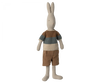 The Maileg Rabbit Size 4, Classic - Knitted Shirt & Shorts is a charming stuffed rabbit toy made from natural linen and cotton fabric. It features a striped sweater in shades of brown, green, and cream, paired with brown shorts. This adorable rabbit has long ears that stand upright and a simplistic stitched face. Part of the bunny and rabbit collection, this toy can stand upright against a plain white background.