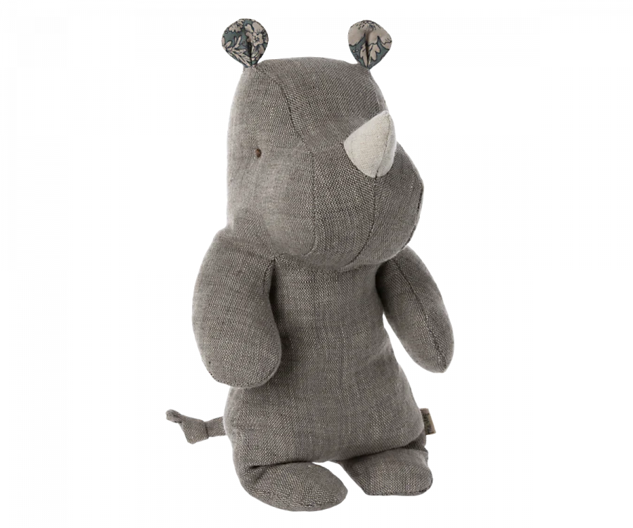 A Small Maileg Rhino plush toy, one of the softest fabric safari friends, stands isolated against a black background, crafted from grey textured fabric with stitched eyes and a small white horn.