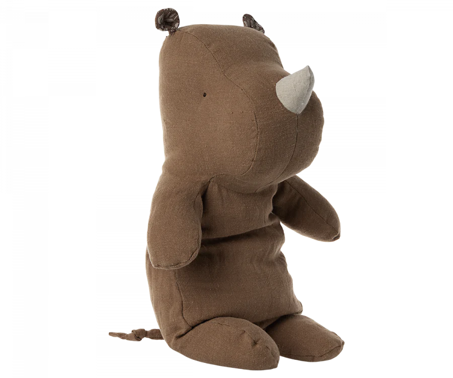 A side view of the Maileg Medium Rhino, a plush toy from the Safari Friends collection. Featuring a brown and beige design with a rounded snout, small ears, tail, and incredibly soft texture, it's perfect for hugs.
