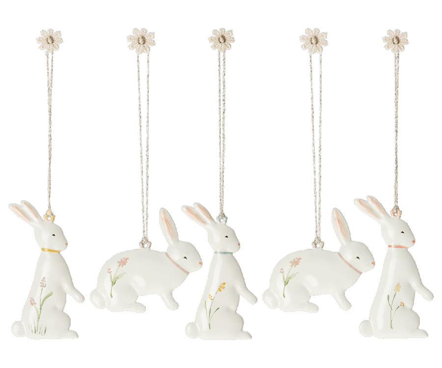 A set of Maileg Easter Bunny Ornaments, 5 pcs. adorned with small flowers and greenery designs. Each rabbit is hanging from a string tied to a small flower at the top. These Easter decorations feature rabbits in various poses, including sitting and standing.