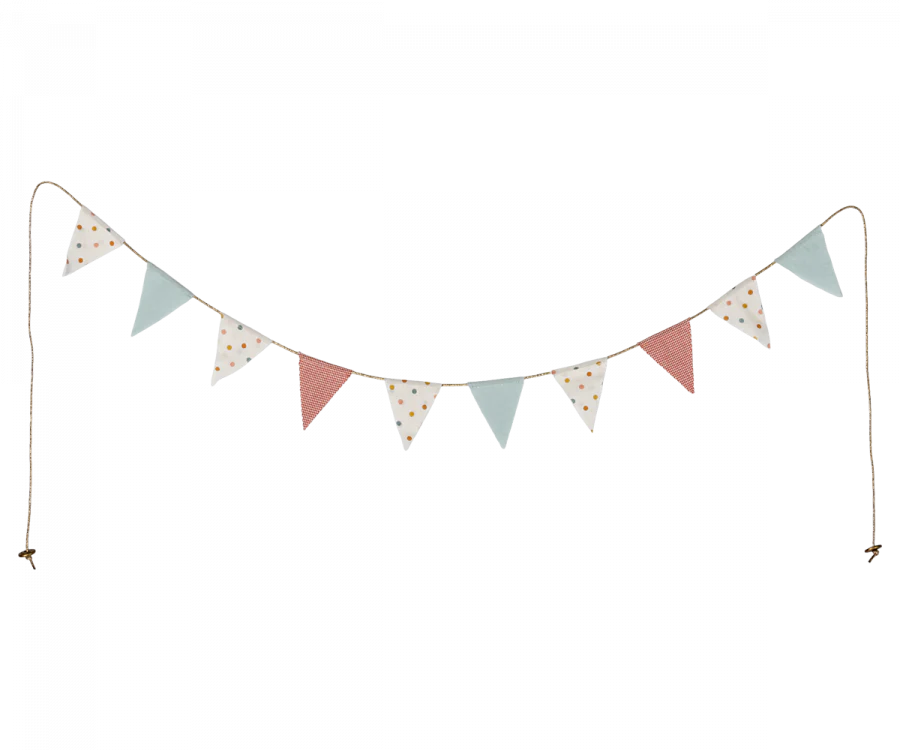 A string of decorative Maileg Miniature Garland bunting with triangular flags in various patterns and colors such as polka dots and stripes, dangling against a black background.