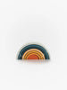 A stack of Handmade Mini Rainbow Stacker - Lagoon in shades of blue, gray, and orange arranged in a semicircular shape, resembling a rainbow, against a plain white background.