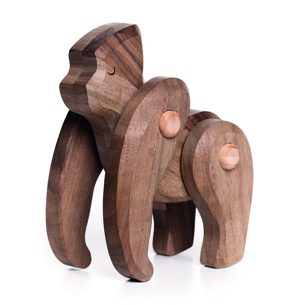 The Handmade Wooden Gorilla is crafted from polished dark wood with a minimalist design. It features rotatable limbs with visible round joints, stands on four legs, and showcases a smooth texture with natural wood grain for an eco-friendly playtime experience.