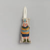 The Coral & Tusk Slopes Fox Ornament is a fabric decoration shaped like a bear wearing a colorful striped parka, green boots, and a cheerful pom-pom cap while holding ski poles. It features a loop for hanging against light gray.