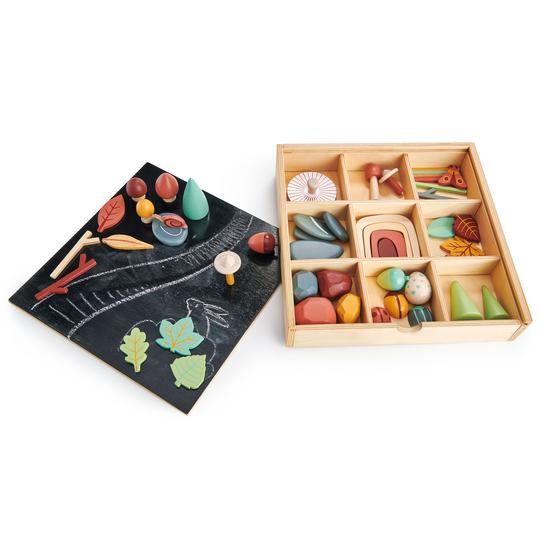My Forest Floor featuring nature-themed shapes and colors arranged next to a chalkboard with drawings, all displayed on a white background for open-ended play.