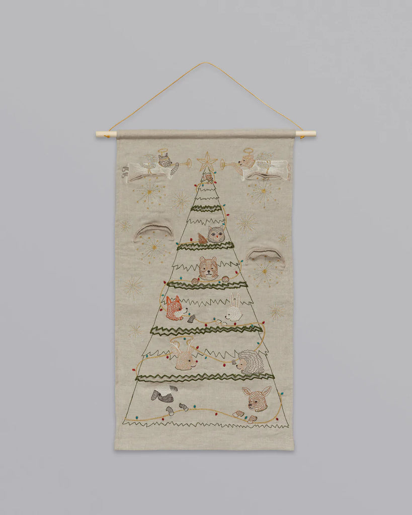 Coral & Tusk Embroidered Advent Calendar wall hanging featuring a countdown to Christmas design with animal motifs, suspended from a wooden dowel against a plain background.