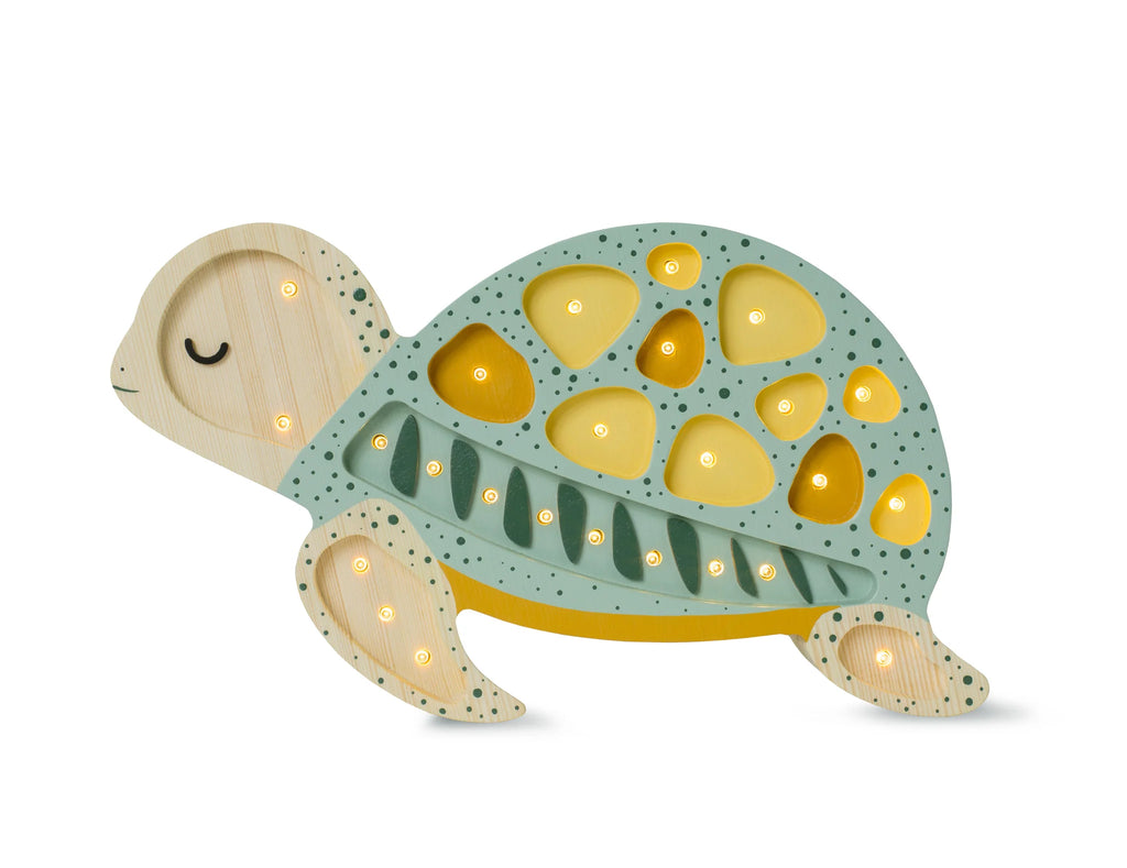 A Little Lights Turtle Lamp, crafted from natural pinewood and painted in green and yellow, with small built-in LED lights illuminating its shell. This charming children's night light has a simplistic design, featuring closed eyes and a content expression.